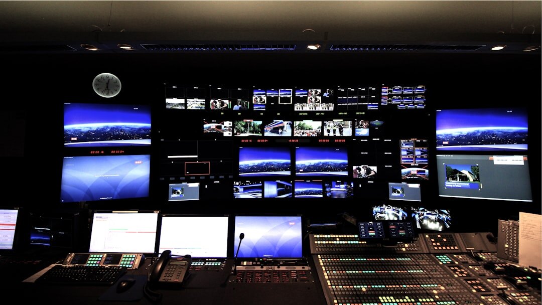 Newsroom control room with multiple broadcast screens