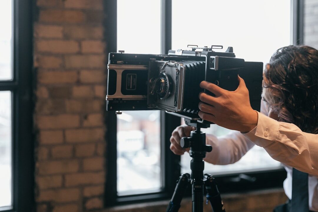 Professional video camera mounted on a tripod in a studio